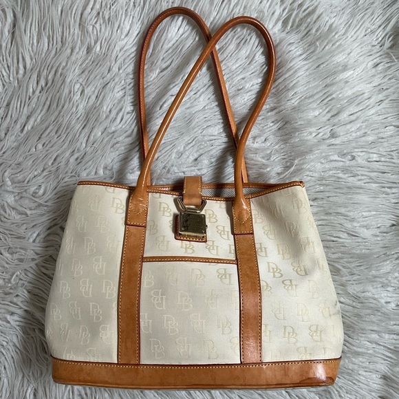 Dooney & Bourke Handbags - Dooney Bourke Beige Canvas Logo Embossed Tan Leather Trim Push Lock Shoulder Bag